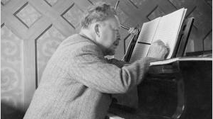 Peterson-Berger at his grand piano.